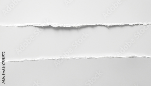 A piece of torn white paper on a white background.