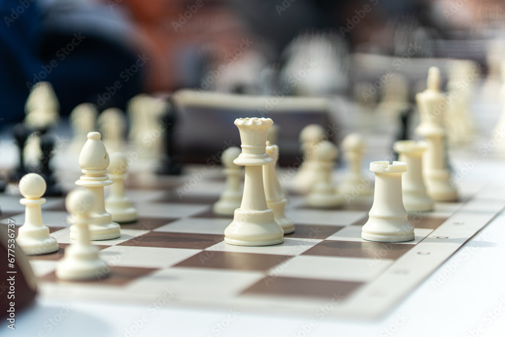 game of chess. move in chess, white pawn. . Large wooden chess set. white chess pieces on board