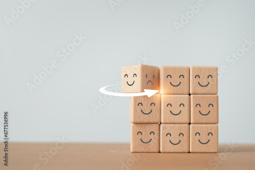 for positive thinking, mental health, service mind, wellness, wellbeing concept, flipped dice from bad temper face to good mood icon on wooden cube blocks with copy space