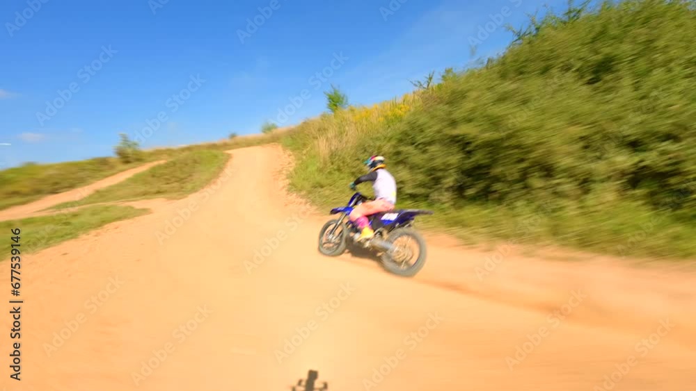 FPV of high-speed motocross bike on track. Concepts of extreme sports, racing, and adrenaline. FPV of high-speed motocross bike on track. Concepts of extreme sports, racing, and adrenaline.