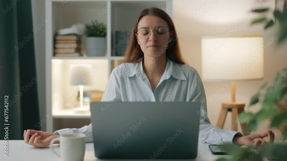 Remote worker student woman in blue shirt practices yoga pose at desk, engaging in breathing exercises to alleviate fatigue in home office Remote worker student woman in blue shirt practices yoga pose at desk, engaging in breathing exercises to alleviate fatigue in home office