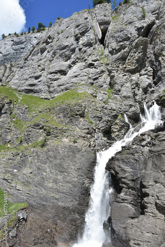 Mountain Waterfall in the Swiss Alps  Bottom Frame Right with Blue Sky in Upper Left Corner