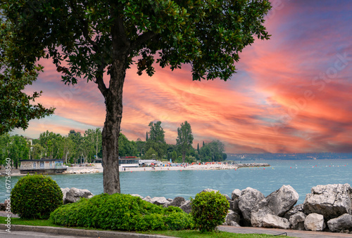 Fototapeta Naklejka Na Ścianę i Meble -  sunset on the lake garda with beach, italy