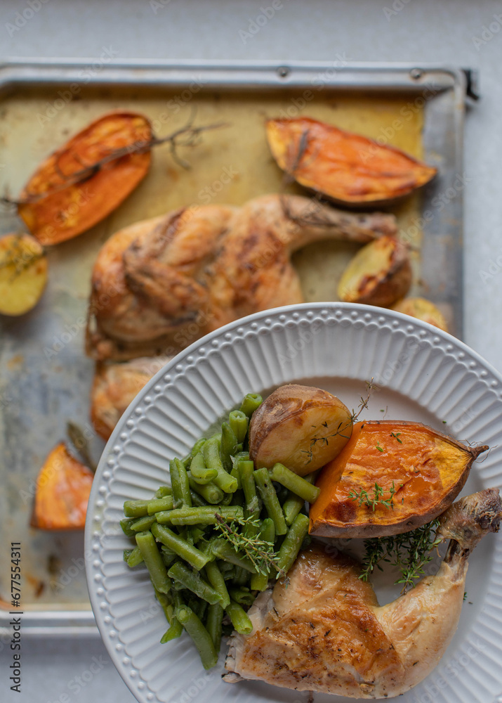 Healthy meal with oven roasted chicken and baked potatoes with rosemary and thyme Healthy meal with oven roasted chicken and baked potatoes with rosemary and thyme
