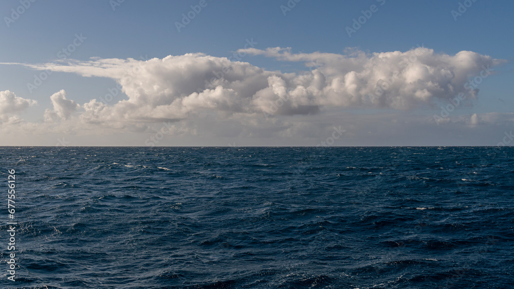 Panorama of beautiful white clouds above the Pacific Ocean in Kauai, Hawaii, United States.
