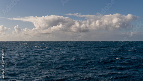 Panorama of beautiful white clouds above the Pacific Ocean in Kauai, Hawaii, United States. 