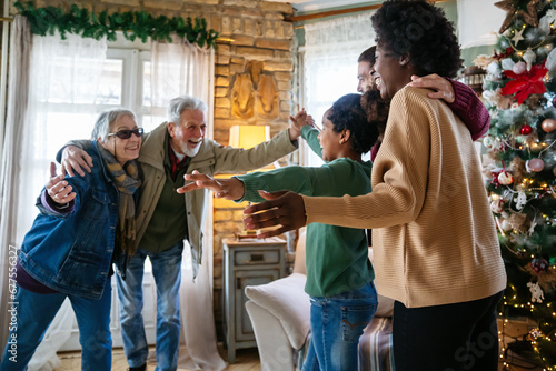 Happy multiethnic multi-generational family enjoying Christmas time together. People love concept. photo