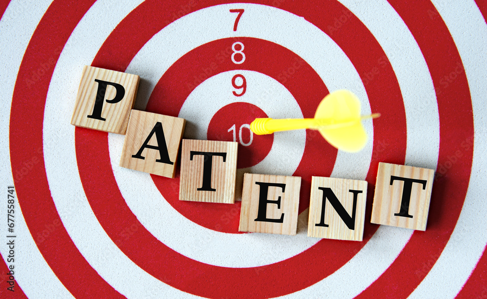 PATENT - word on wooden cubes on dartboard background PATENT - word on wooden cubes on dartboard background