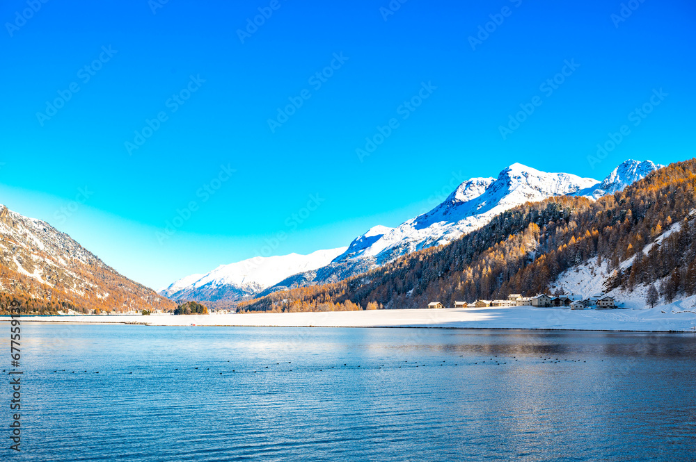 Engadine, Switzerland, Sils Maria lake, the village of Isola and the snowy landscape.
