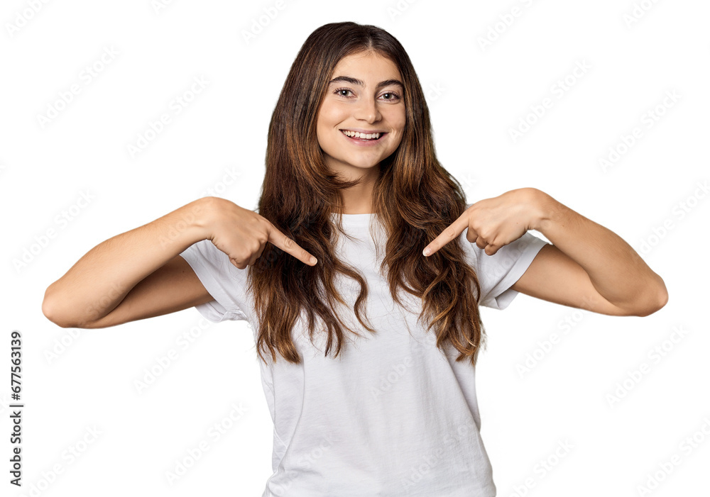 Young Caucasian woman in studio setting surprised pointing with finger, smiling broadly.