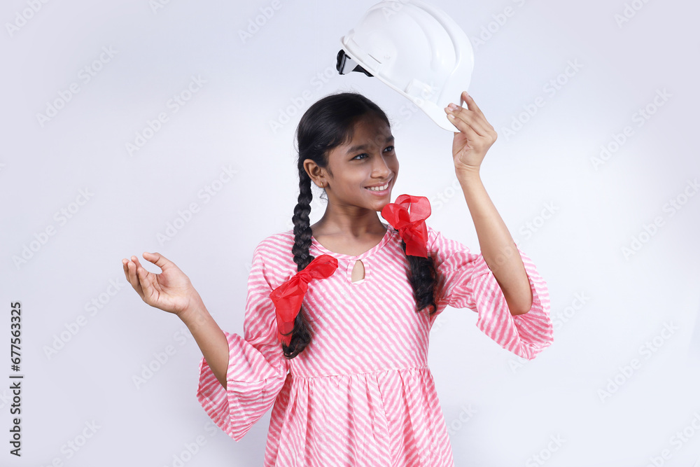 Portrait of Happy school kid as construction worker. Better and stable future concept. The school child is holding construction manager helmet in hand. Portrait of Happy school kid as construction worker. Better and stable future concept. The school child is holding construction manager helmet in hand.
