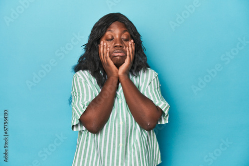 Fotografie Young african american curvy woman whining and crying disconsolately