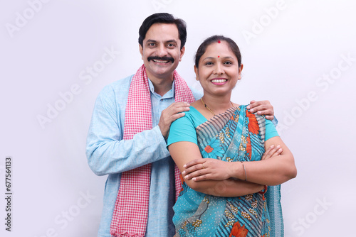 Indian rural happy villager couple standing together on a white background. photo