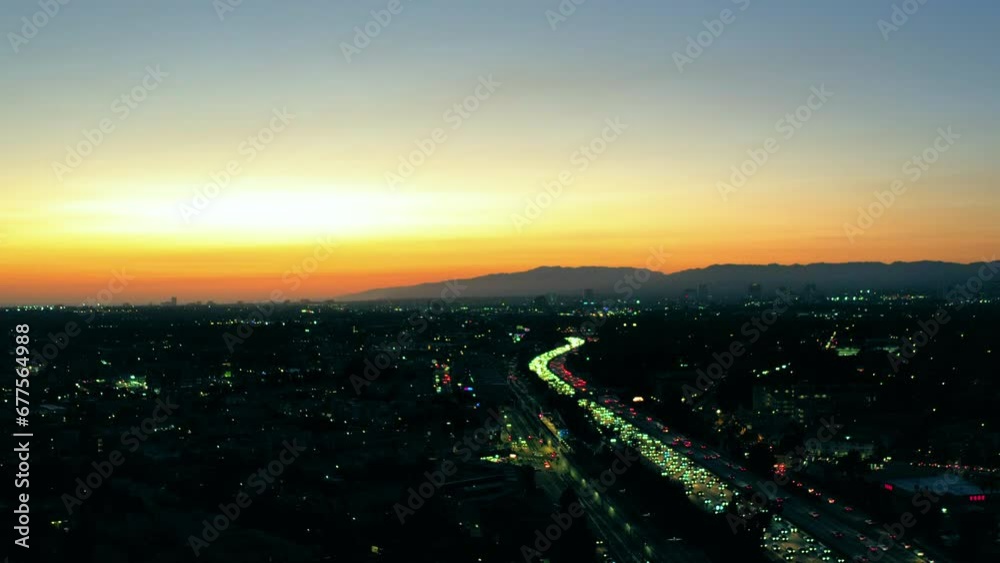 Aerial Shot Of Illuminated Vehicles Moving On Road In City, Drone Flying Forward Over Dark Landscape During Sunset - Culver City, California Aerial Shot Of Illuminated Vehicles Moving On Road In City, Drone Flying Forward Over Dark Landscape During Sunset - Culver City, California