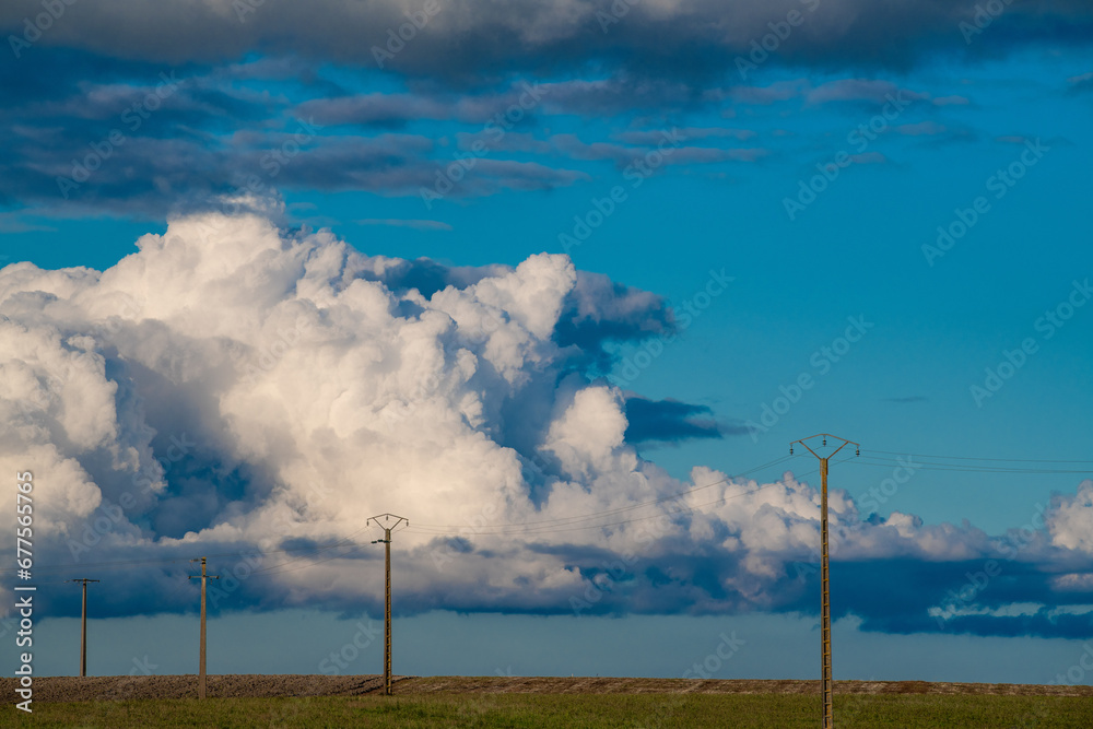 Power line on landscape background Ornamental clouds, dramatic sky, epic storm landscape. High quality photo Power line on landscape background Ornamental clouds, dramatic sky, epic storm landscape. High quality photo