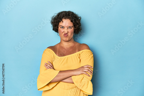 Wallpaper Mural Young Caucasian woman with short hair frowning face in displeasure, keeps arms folded