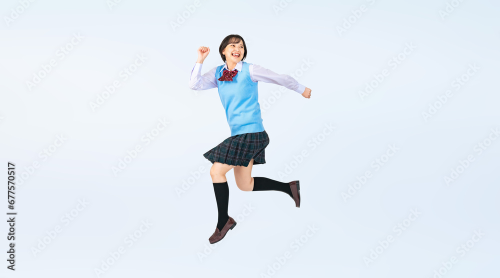ジャンプする制服を着た女子学生　切り抜き全身写真（切り抜き背景透過PNGも販売しております。作成者リンクから「PNG」で検索してください）