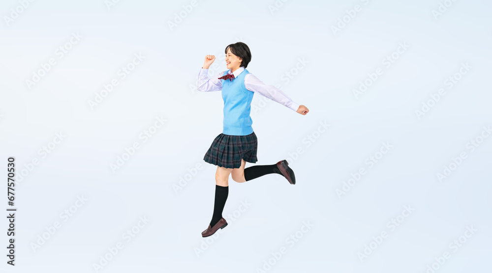 Fototapeta premium ジャンプする制服を着た女子学生 切り抜き全身写真（切り抜き背景透過PNGも販売しております。作成者リンクから「PNG」で検索してください）