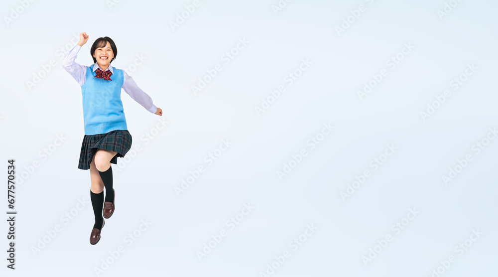 ジャンプする制服を着た女子学生　切り抜き全身写真（切り抜き背景透過PNGも販売しております。作成者リンクから「PNG」で検索してください）
