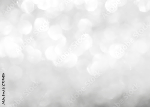 Silver glitter blur background of bright sparkling white light glittering bokeh chandelier illumination for winter Christmas holiday decoration backdrop