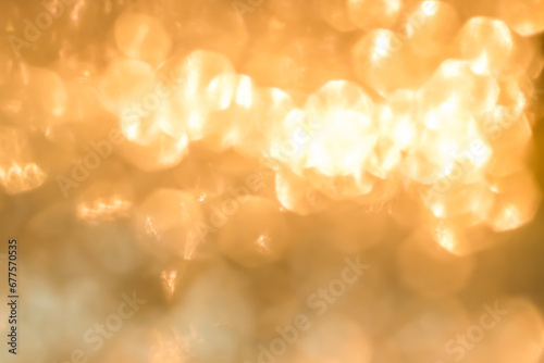 Gold glitter blur abstract background of bright sparkling white light glittering bokeh chandelier illumination for Christmas holiday decoration backdrop