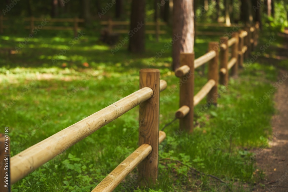 Wooden fence barrier at farm grounds for cattle and territory protection Wooden fence barrier at farm grounds for cattle and territory protection