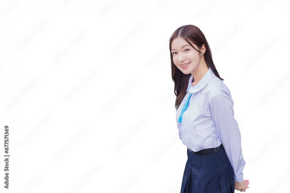 Beautiful high school Asian student girl in school uniform stands and smiles happily with braces on her teeth while she looks at camera isolated on white background. Beautiful high school Asian student girl in school uniform stands and smiles happily with braces on her teeth while she looks at camera isolated on white background.