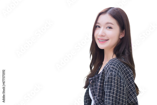 Portrait of beautiful long haired young Asian woman in black pattern coat with braces on teeth walking and smiling while isolated on white background. © nut_foto