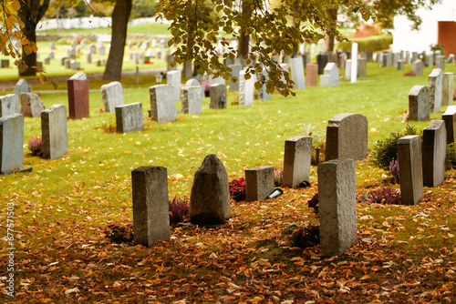 Graveyard on a sunny day. Cemetery graveyard white and grey tombstones.