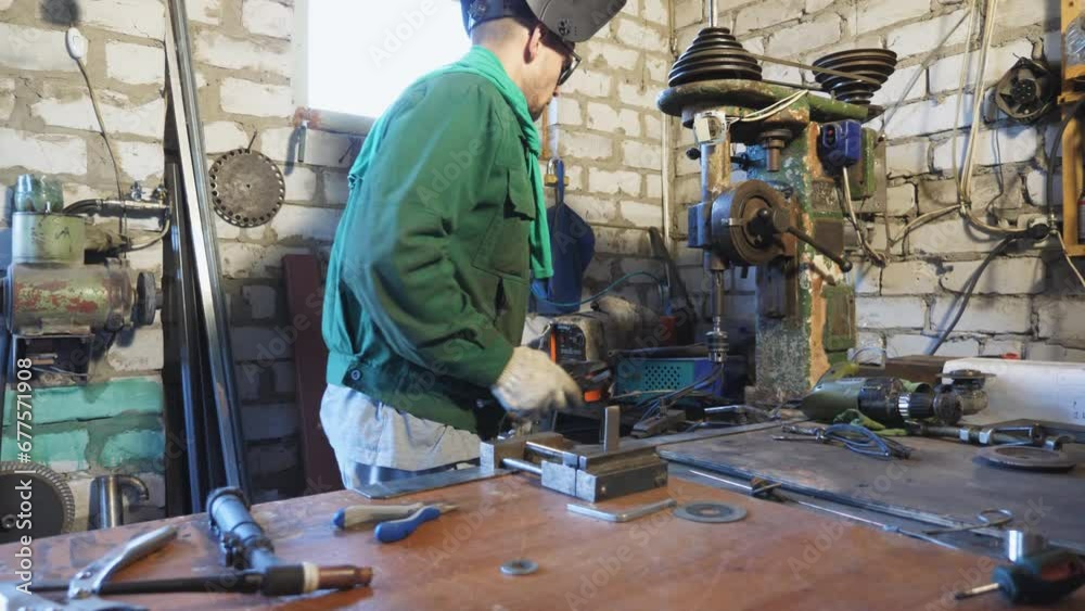 Cheerful repairman in protective eyewear fooling around during working in workshop. Happy mechanic in uniform enjoying and having fun in garage. Young man dancing funny at workplace. Dolly shot Cheerful repairman in protective eyewear fooling around during working in workshop. Happy mechanic in uniform enjoying and having fun in garage. Young man dancing funny at workplace. Dolly shot