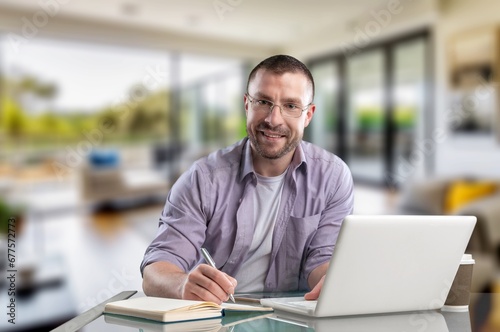 Happy smiling professional businessman sitting at office