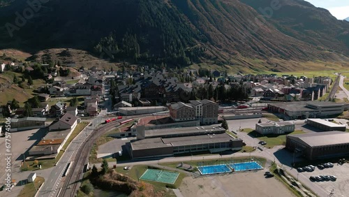 Aerial shot of the village of Andermatt in the canton of Uri in Switzerland. Railroad, tracks and tennis court photo