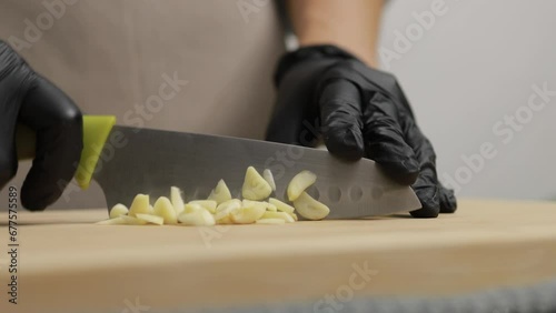 Kitchen Maestro at Work. Chef Precision Chopping Garlic, Creating Culinary Magic with Fresh Herbs in the Comfort of Home.
