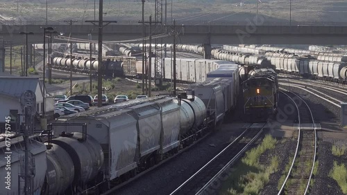 Freight train passes railway yards, Green River, Wyoming, USA