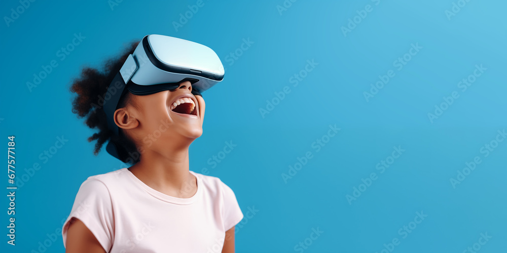 Young girl getting experience using VR headset glasses isolated on a blue background with copy space Young girl getting experience using VR headset glasses isolated on a blue background with copy space