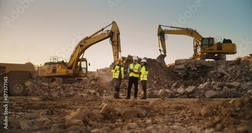 Construction Site With Excavators on Sunny Day: Diverse Team Of Male And Female Real Estate Developers Discussing Project. Engineer, Architect, Inspector Talking About Apartment Building, Using Tablet