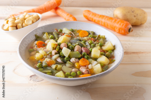 Vegetable and legume minestrone served with croutons. Complete vegan dish ideal for lunch and dinner. Italian minestrone.