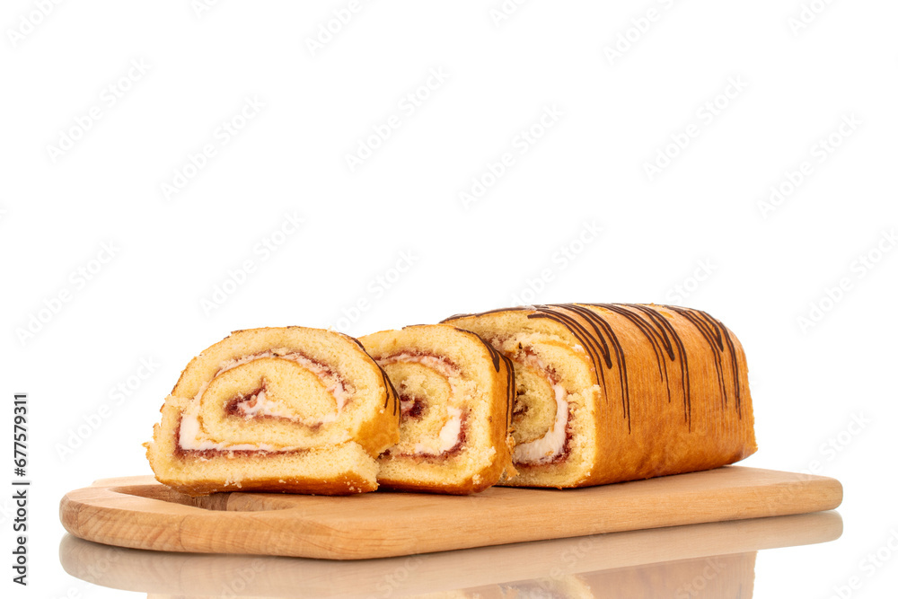 One delicious cherry roll cut into slices on a bamboo kitchen board, macro, isolated on white background. One delicious cherry roll cut into slices on a bamboo kitchen board, macro, isolated on white background.