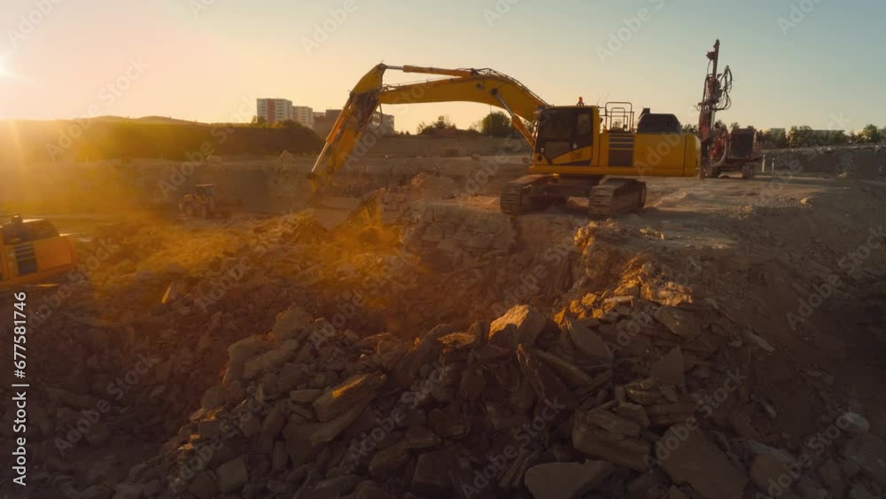 Aerial Drone Shot Of Construction Site On Sunny Day: Industrial Excavators Digging Rocks To Lay Foundation For A New Apartment Building. People Using Heavy Machinery To Complete A Real Estate Project.