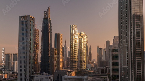 Many towers and skyscrapers with traffic on streets in Dubai Downtown and financial district morning timelapse.