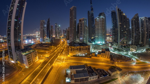Aerial panorama of Dubai Downtown skyline with many towers night to day timelapse.