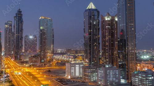 Business bay district skyline with modern architecture night to day timelapse from above. © neiezhmakov