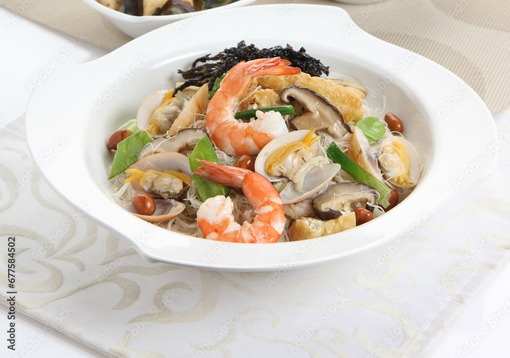 traditional chinese wok stir fried bee hoon noodle mee goreng with clam prawn seafood in plate on grey vintage background cafe hotel luxury halal food restaurant banquet menu traditional chinese wok stir fried bee hoon noodle mee goreng with clam prawn seafood in plate on grey vintage background cafe hotel luxury halal food restaurant banquet menu