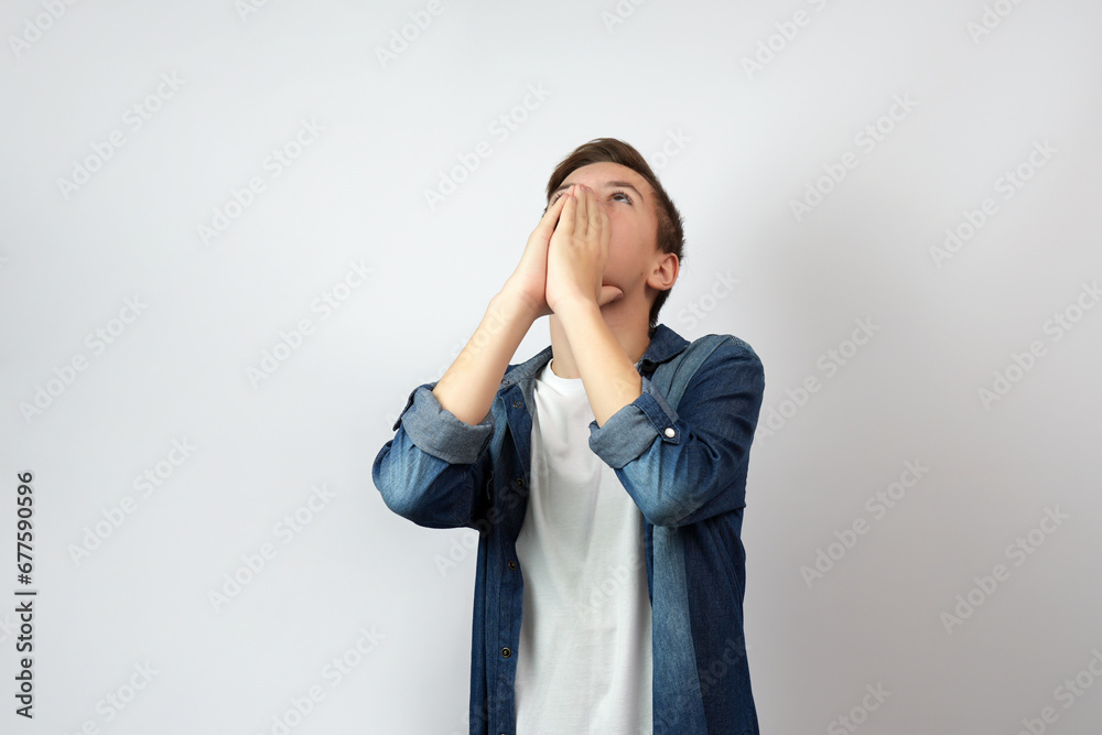 Portrait of praying boy, holding palms on his face. Portrait of praying boy, holding palms on his face.