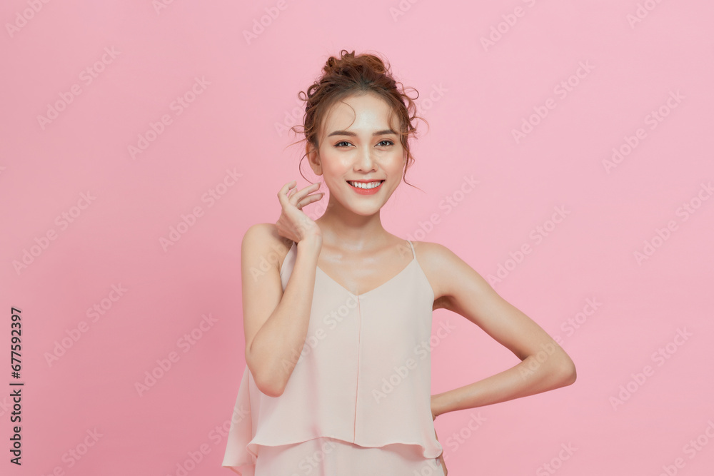 Young Asian beauty woman with korean makeup on face and perfect skin on isolated pink background. Young Asian beauty woman with korean makeup on face and perfect skin on isolated pink background.