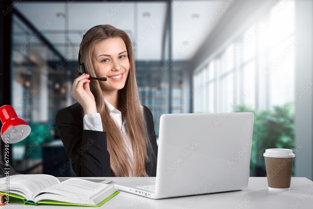 Portrait of business woman, using headset for online communication Portrait of business woman, using headset for online communication