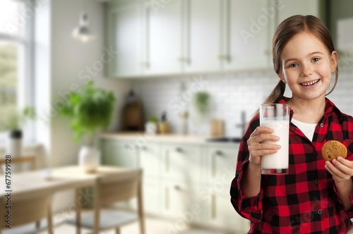 healthy young girl drinking milk at home.