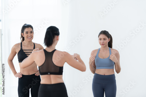 Portrait of a group of female and male athletes standing together in fitness studio