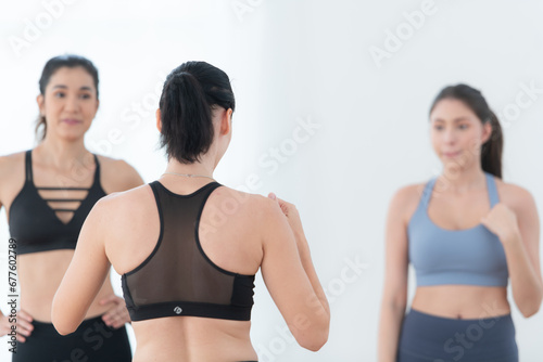 Portrait of a group of female and male athletes standing together in fitness studio