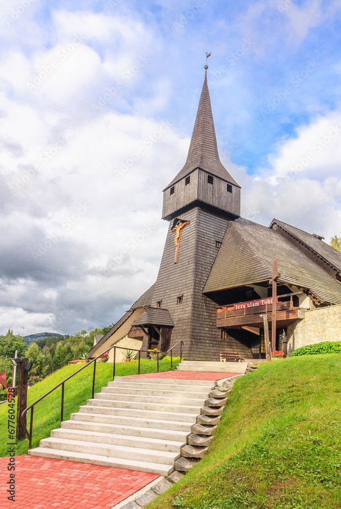 The wooden parish church of the Finding of the Holy Cross in the district Głębce in the tourist town - Wisła in the Silesian Beskids (Poland).